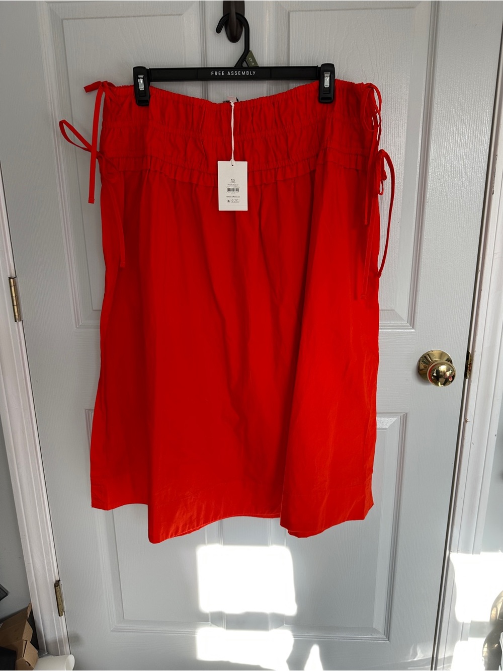 Women's Fire Orange Midi Skirt with side slit and tie details.